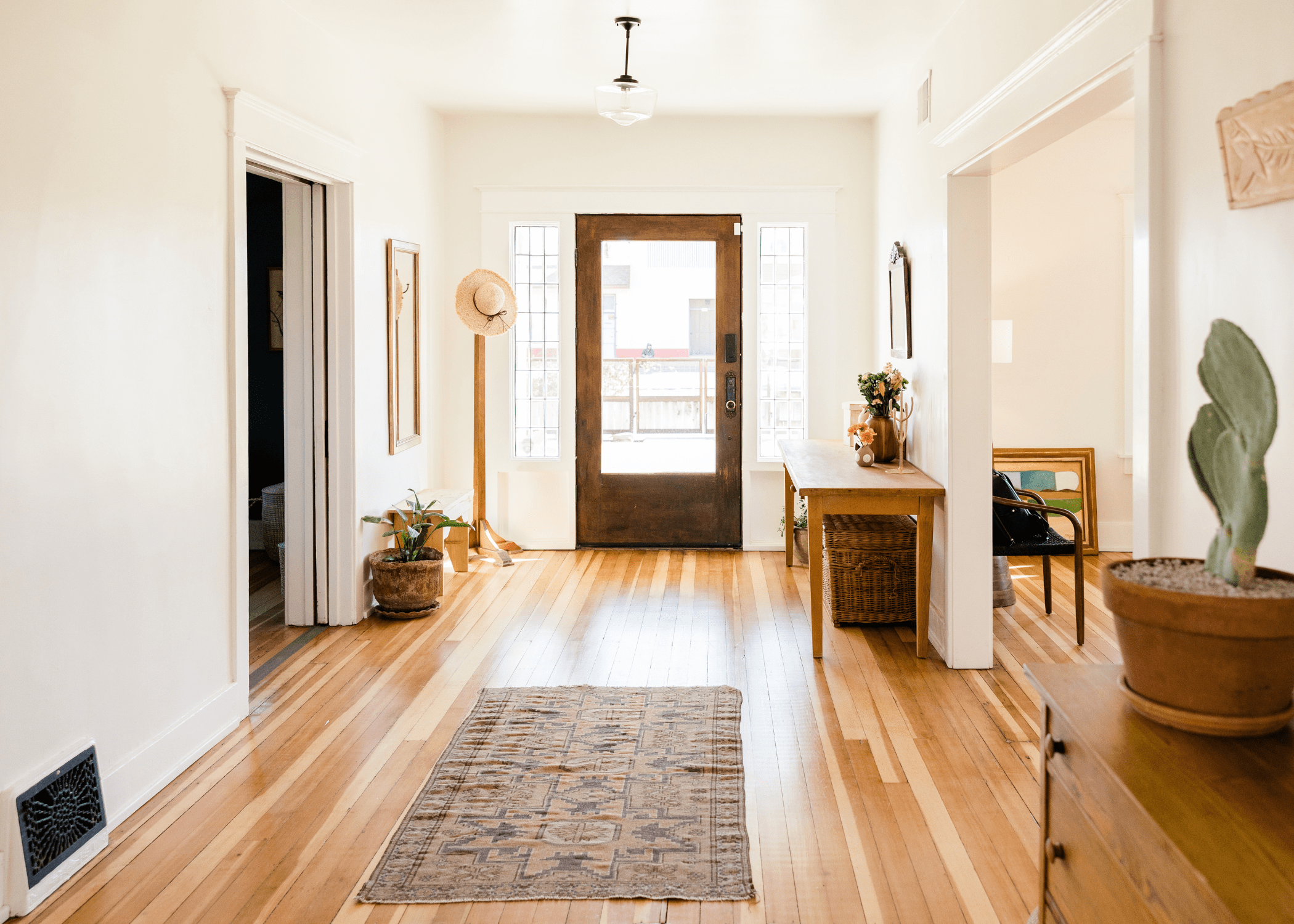 large open hallway entry with console table and coat rack
