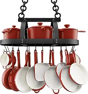 red pots and cookware hanging on black wrought iron rack