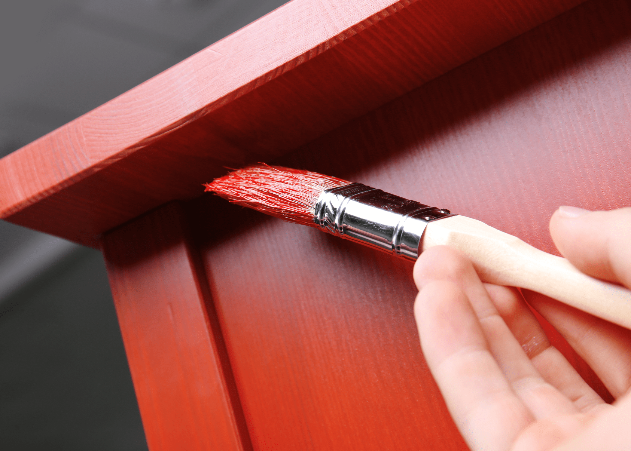 painting underneath a piece of furniture red close up