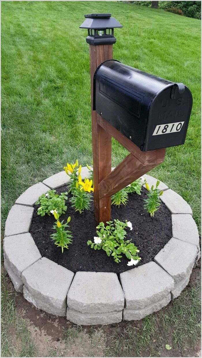 planter mailbox black with wood post and garden stones