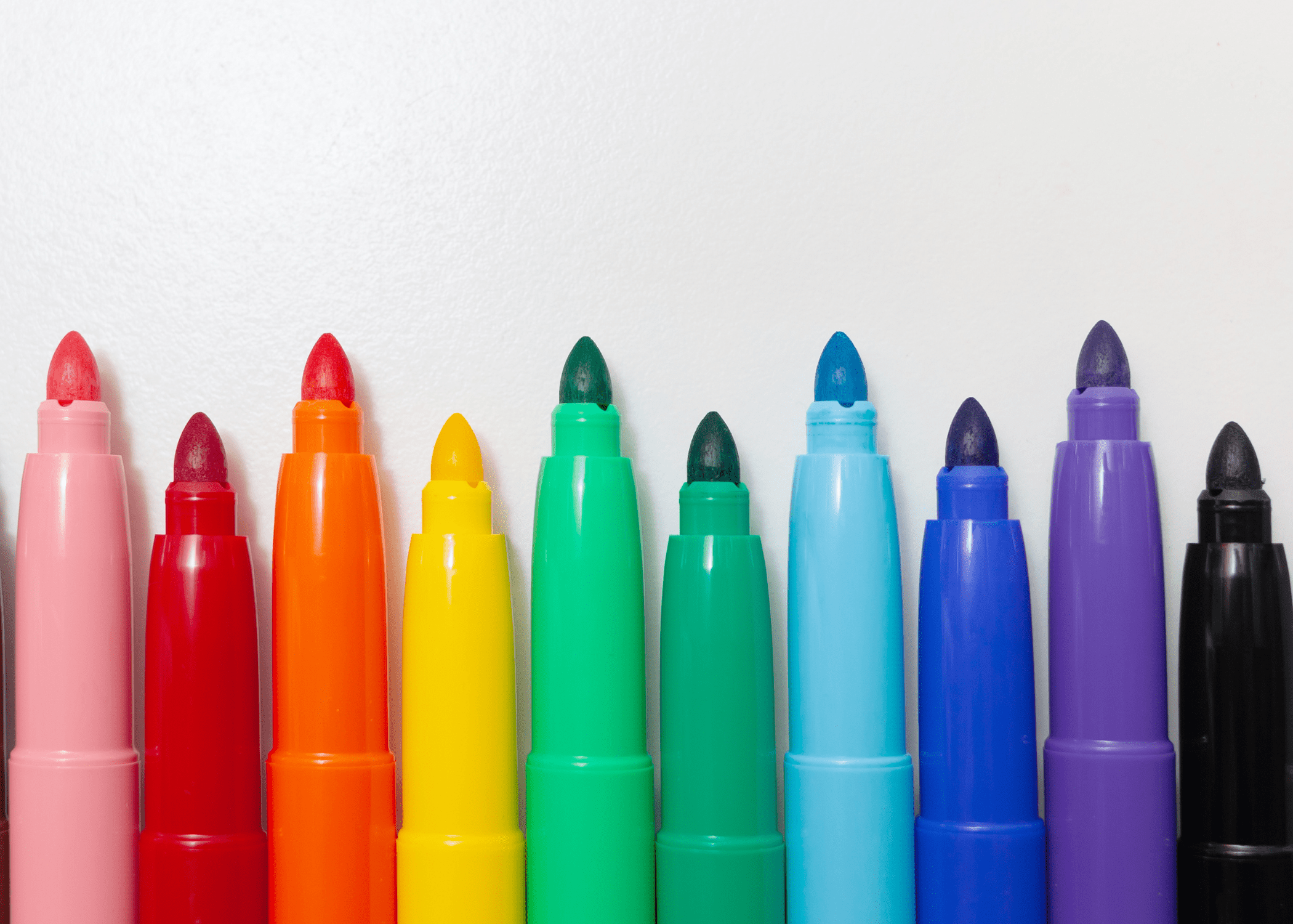 colorful sharpies on white background