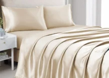 cream silk sheet set on queen bed