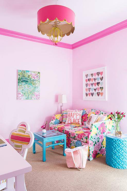 A Stray Dog Designs Sally Pendant hangs from a light pink ceiling accented with pink crown moldings in a gorgeous pink and blue girls bedroom featuring a hearts art piece hung from a light pink wall over a modern colorful loveseat. The loveseat sits beside a blue stool accent table and facing a blue lacquer coffee table.