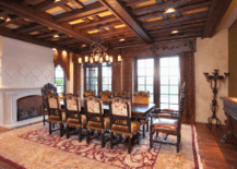 A formal dinning room with rich dark wood ceiling.