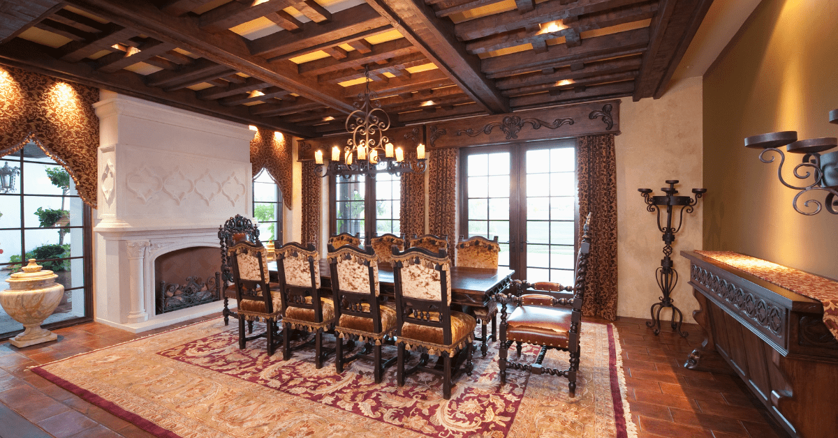 A formal dinning room with rich dark wood ceiling.