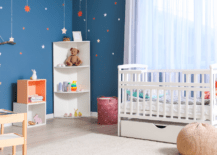 A colorful nursery room that is small.