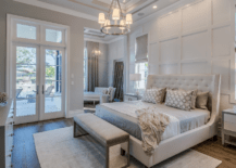 A large master bedroom with big bed and seating.