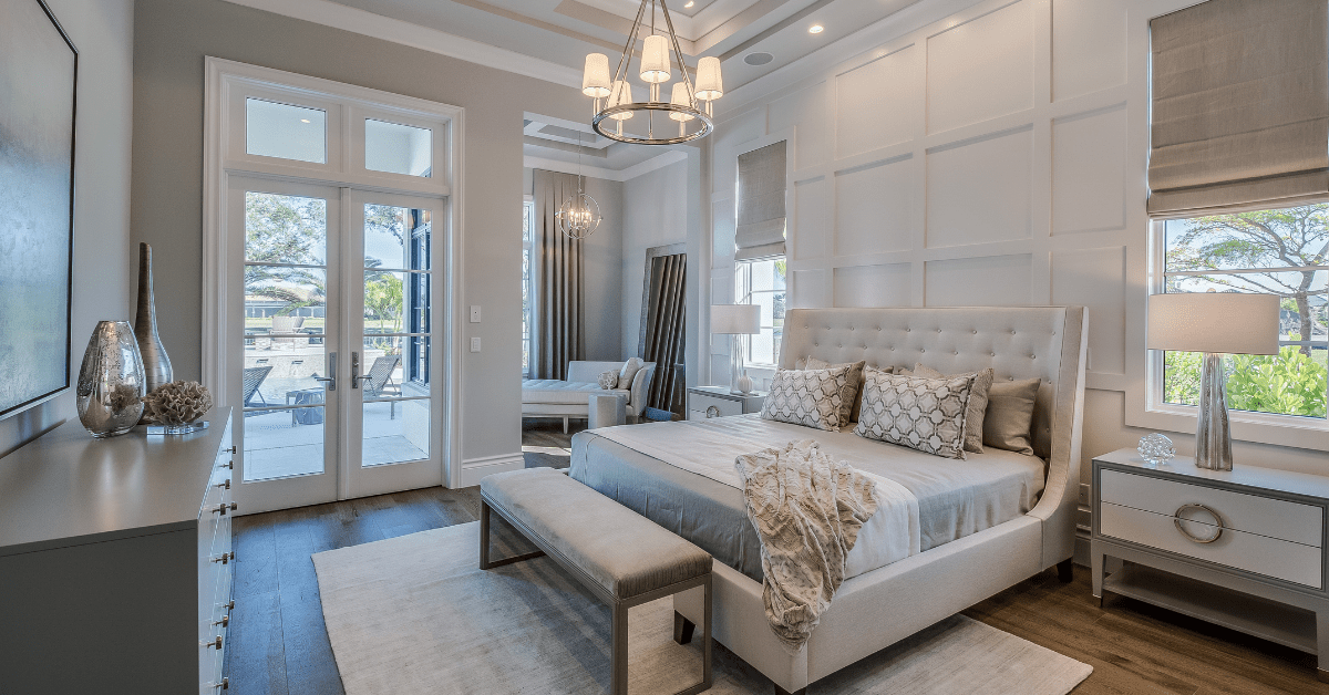 A large master bedroom with big bed and seating.