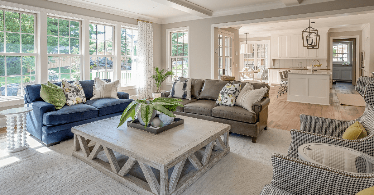 Open concept living room with large grey table.