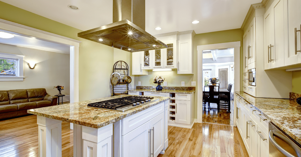 A kitchen island with built-in stove and ventilation hood.