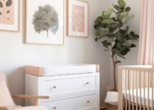 A small nursery with dresser and chair.