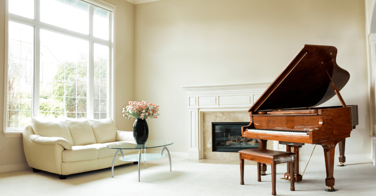 A music room with piano and large windows for natural light.