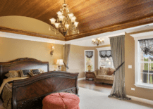 A bedroom with curved wood ceiling.