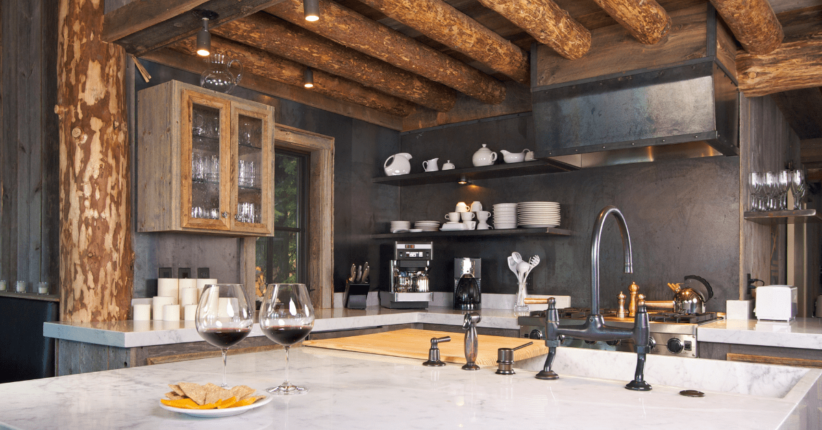 A rustic kitchen with black walls and wood beam ceiling.