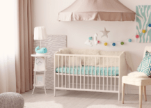 Pink small nursery with cute decor.