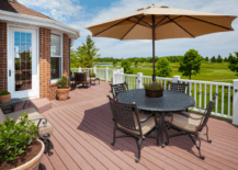 large deck with patio table and umbrella