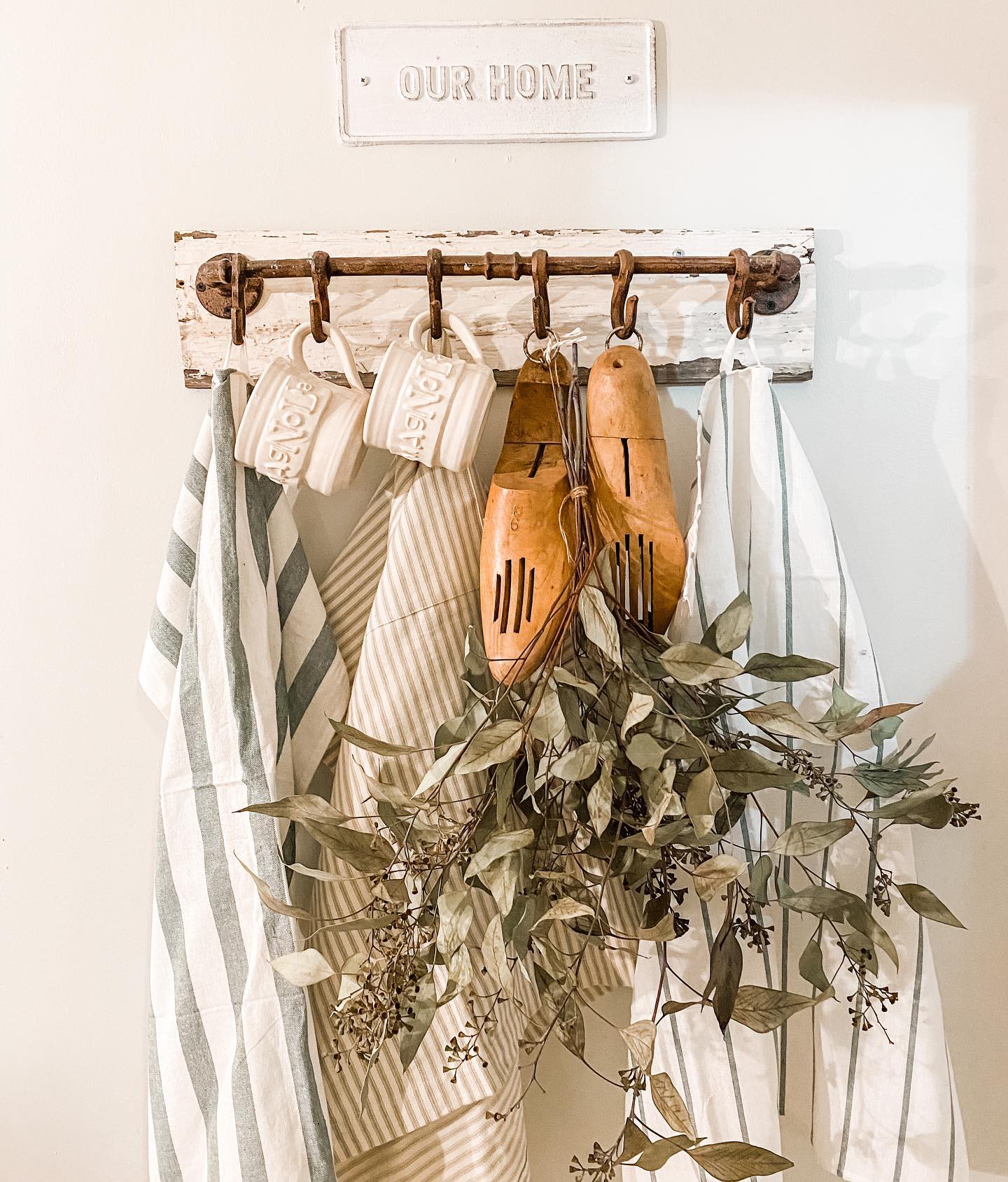 antique hook rack with tea towels and seeded eucalyptus