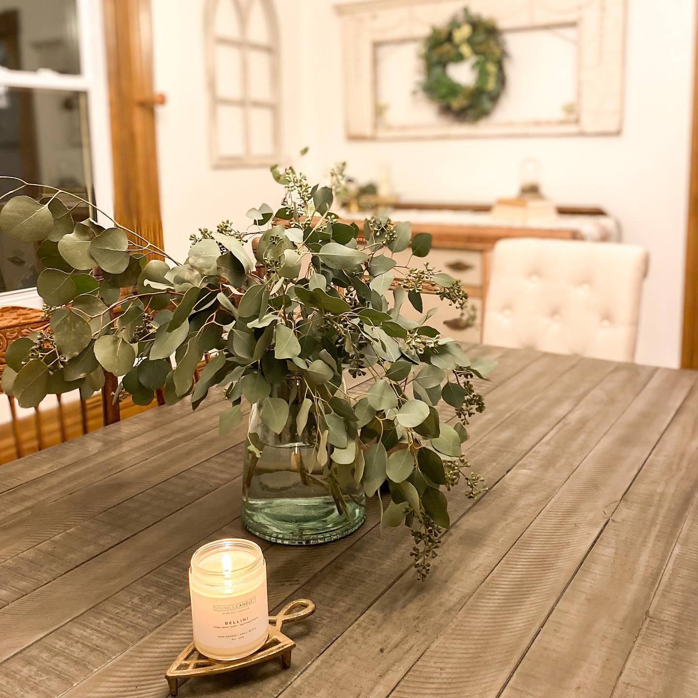 dining table seeded eucalyptus on table lit candle