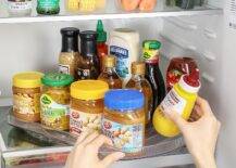 lazy susan in refrigerator with condiments on it