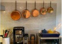 hanging pot rack with copper pots in kitchen