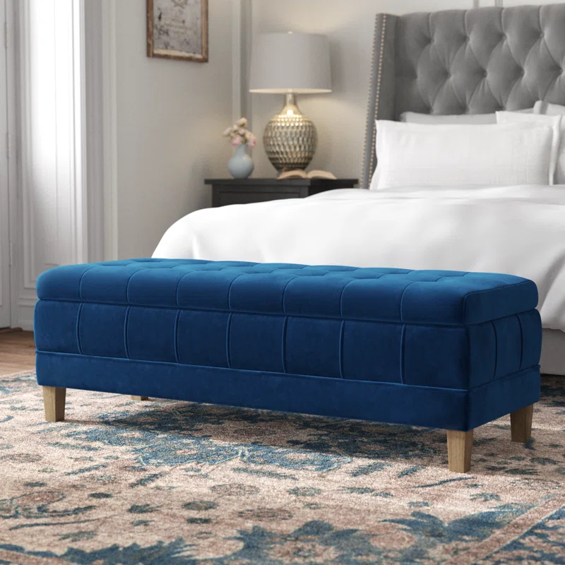 blue velvet storage ottoman at end of bed