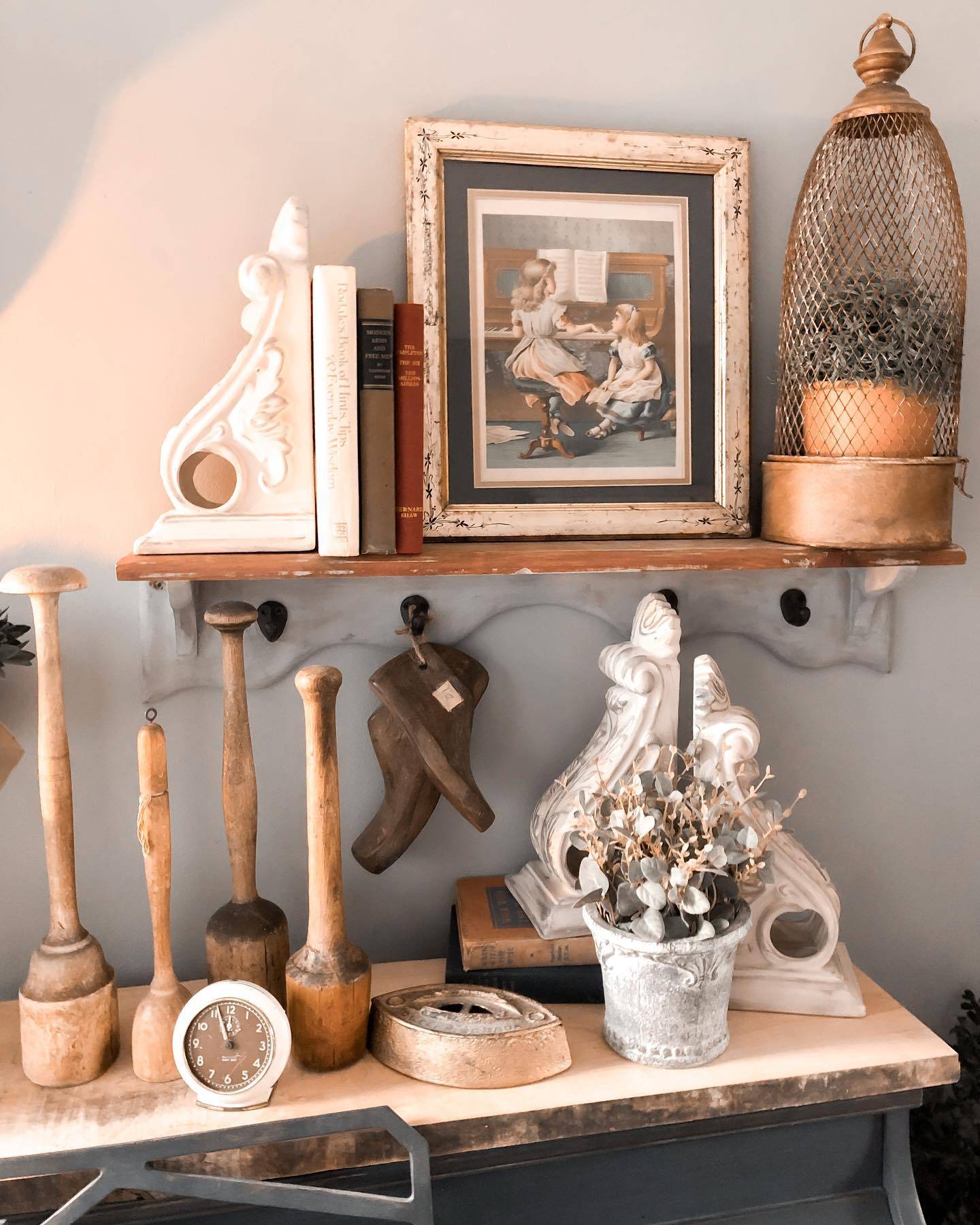 vintage antique decor on shelf with wood mashers corbels and vintage art