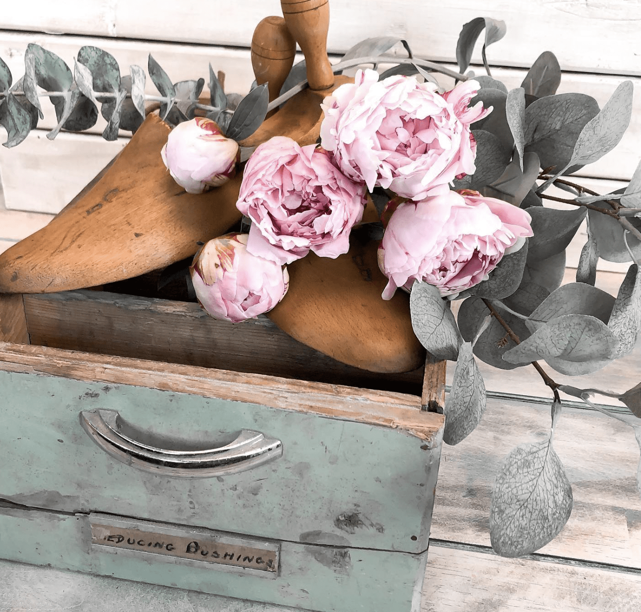 vintage drawer with shoe forms pink peonies and eucalytpus