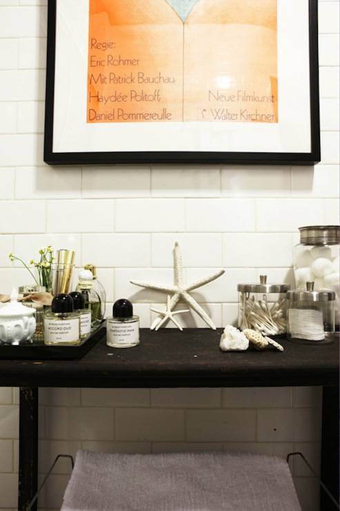 Chic bathroom with vintage cart, glass canisters, starfish and apothecary jars.