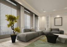 living room with floor to ceiling windows covered with blinds