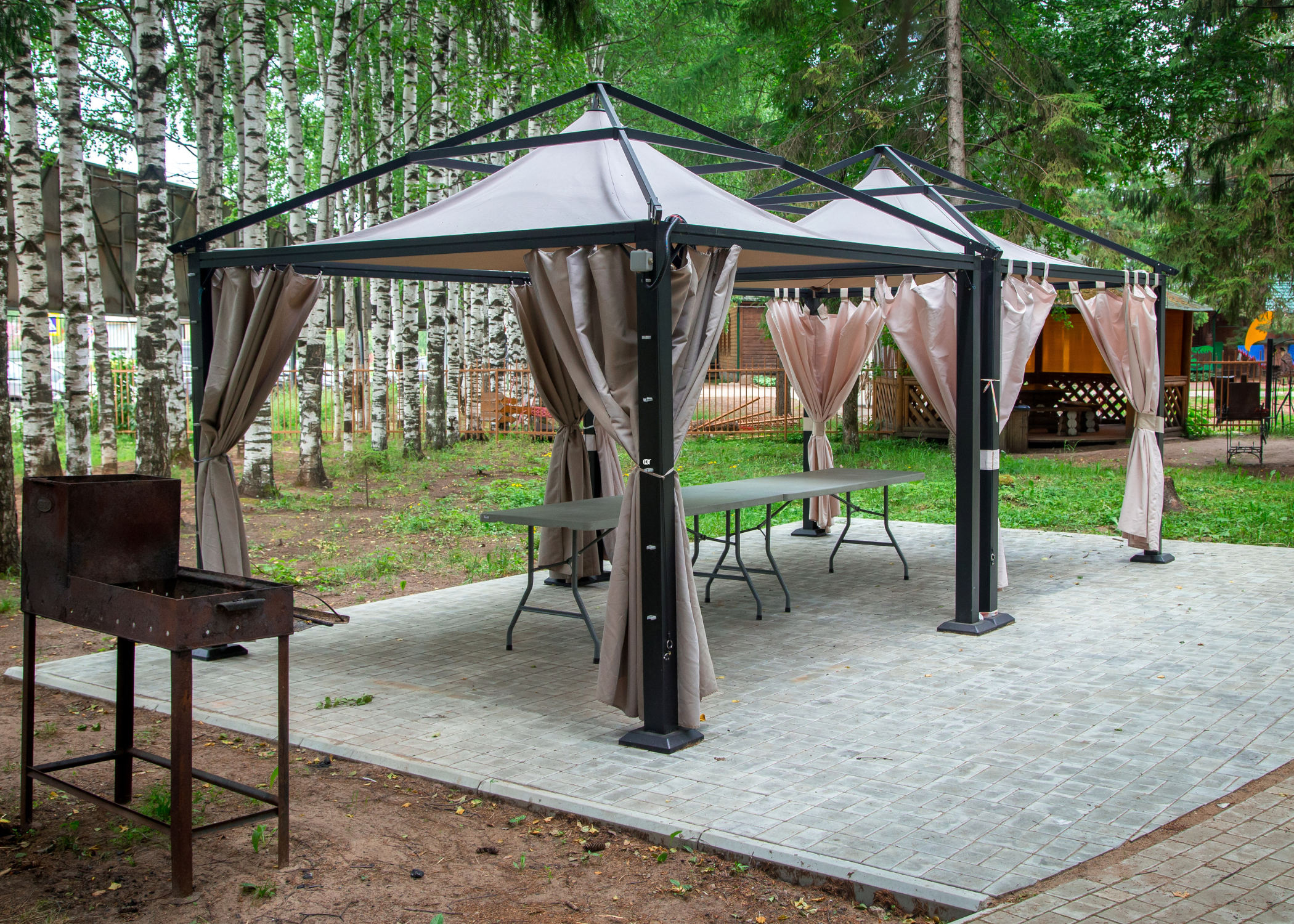 Canvas shades on two metal pergolas.