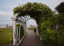White wooden garden arch with greenery.