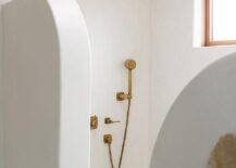 Cottage style open shower features an antique brass shower kit.