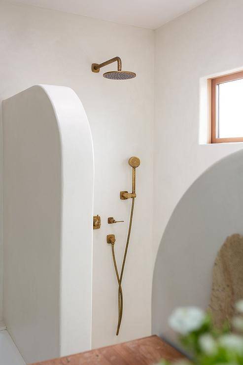 Cottage style open shower features an antique brass shower kit.