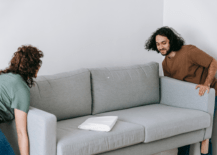 woman and man moving a couch