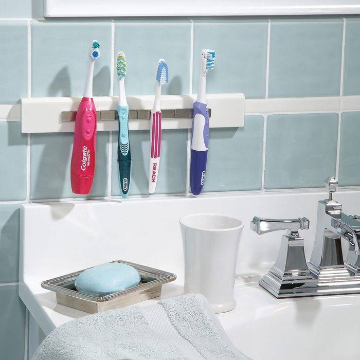 magnetic strip toothbrush holder by sink