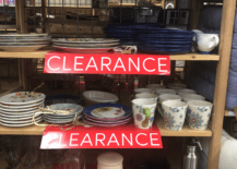 clearance sign on shelves with dishes