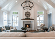 A large living room with vaulted ceiling and chandelier lighting.