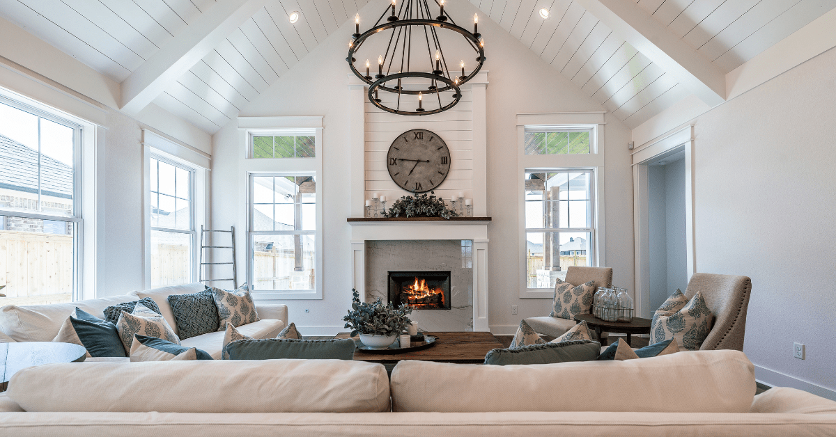 A large living room with vaulted ceiling and chandelier lighting.