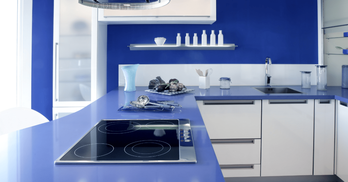 A dark blue kitchen with white accents.