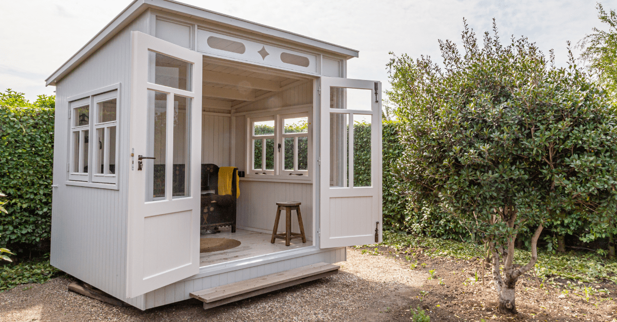 A white themed shed with open doors.