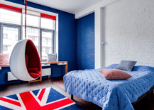 A hanging chair in a bedroom with UK flag rug.