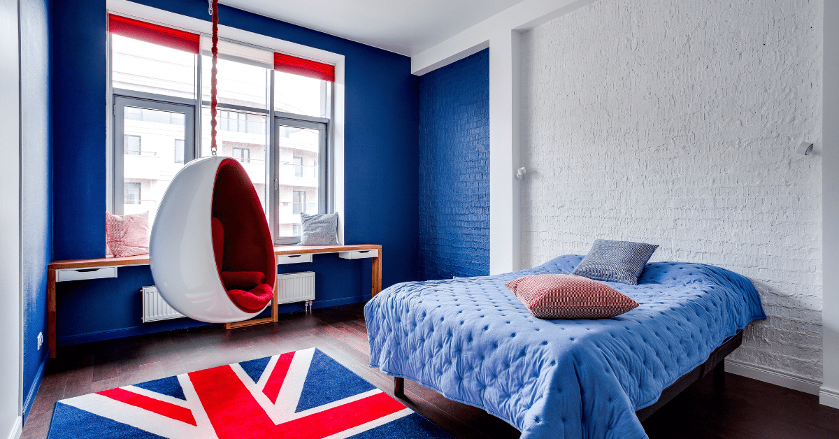 A hanging chair in a bedroom with UK flag rug.