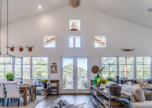 A spacious living room with vaulted ceiling and large furniture