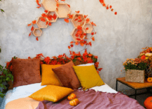 A fall-themed bed with shelves above it.