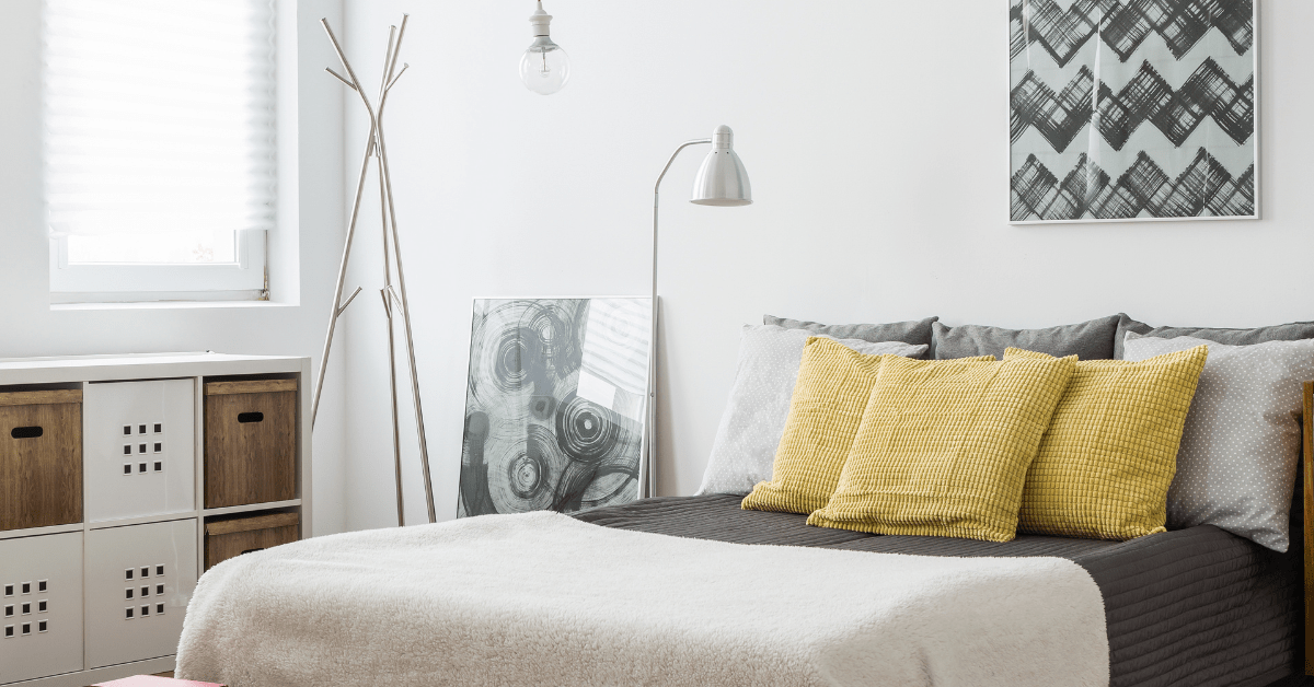 Modern bed with art above its headboard.