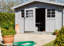 A grey shed with door open.