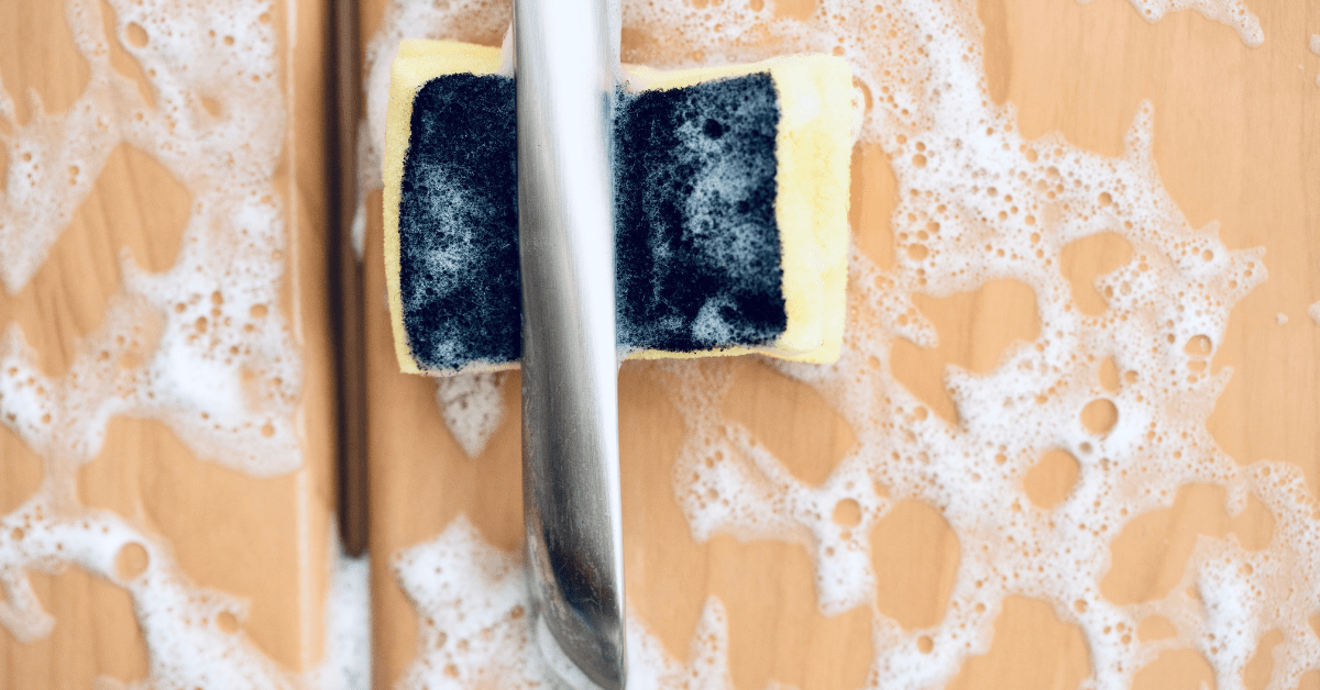 Soapy kitchen cabinet with sponge in the handle.