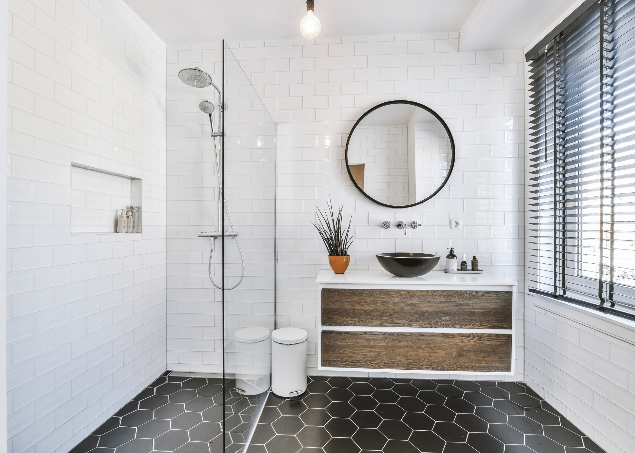 white and black 3/4 bathroom with open shower