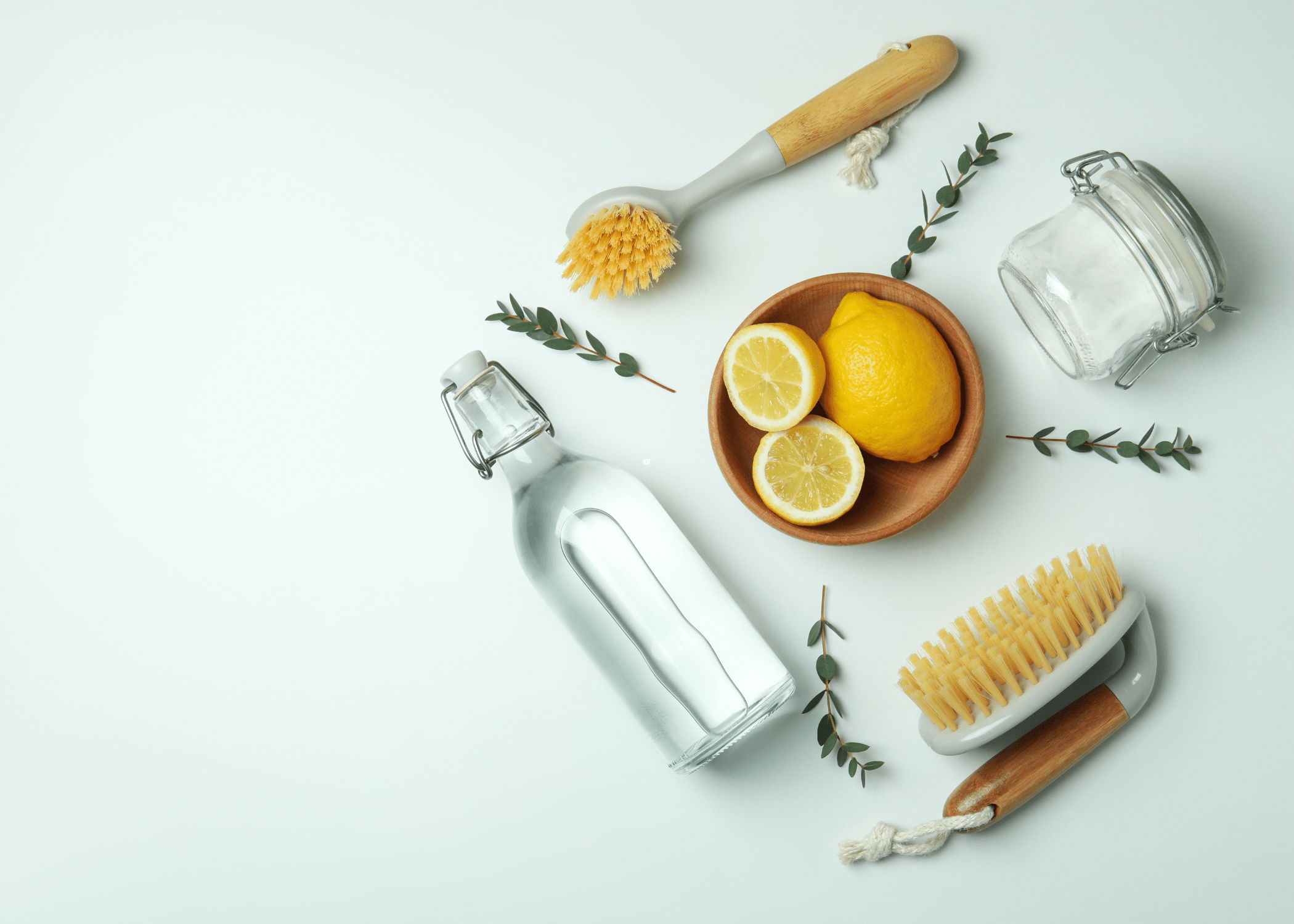 flat lay of lemon vinegar and baking soda with scrub brushes