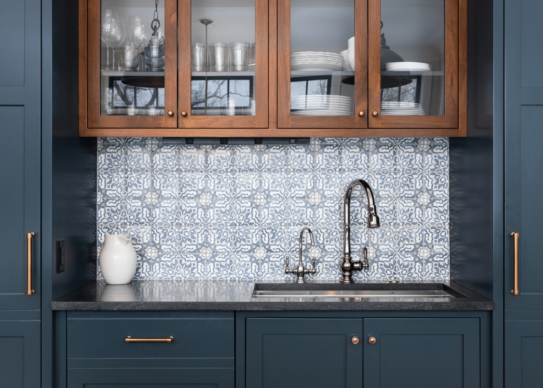 dark blue and wood kitchen cabinets with pattern backsplash